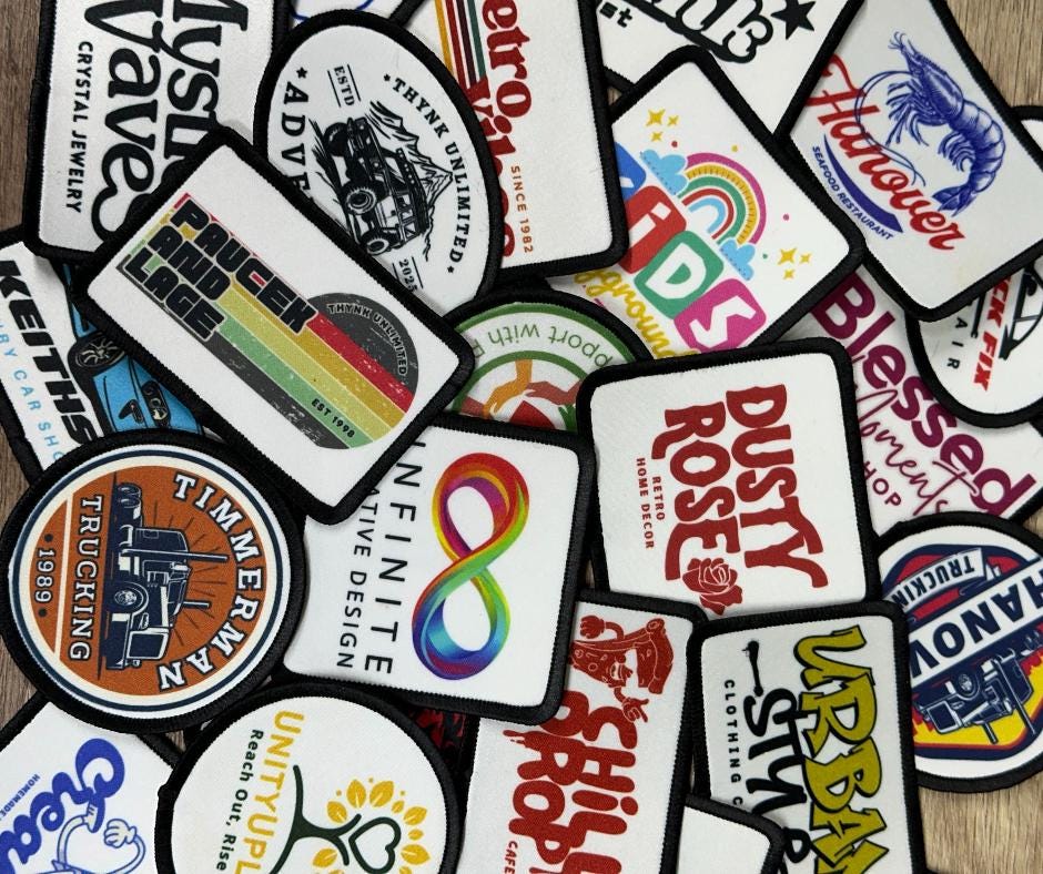 a pile of colorful stickers sitting on top of a wooden table