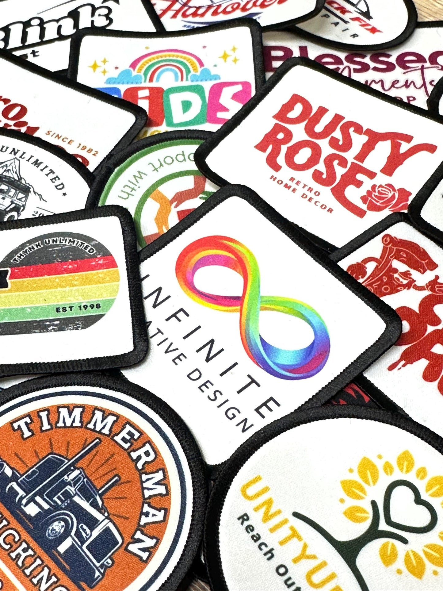 a collection of various logos and patches, including a rainbow-colored infinity symbol, a truck logo, and other abstract designs.