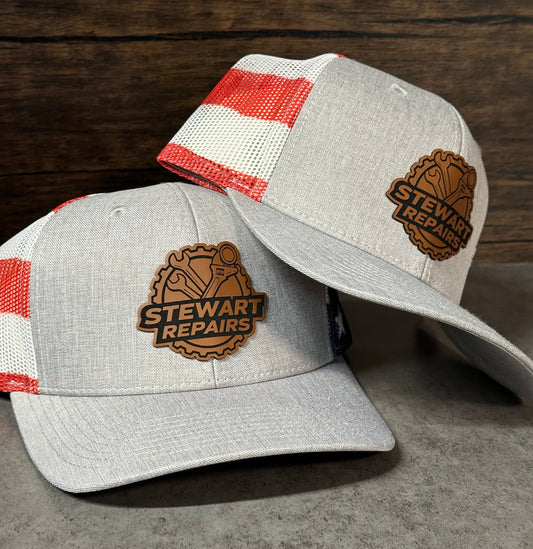 Two gray caps with red and white striped interior on a wooden surface

