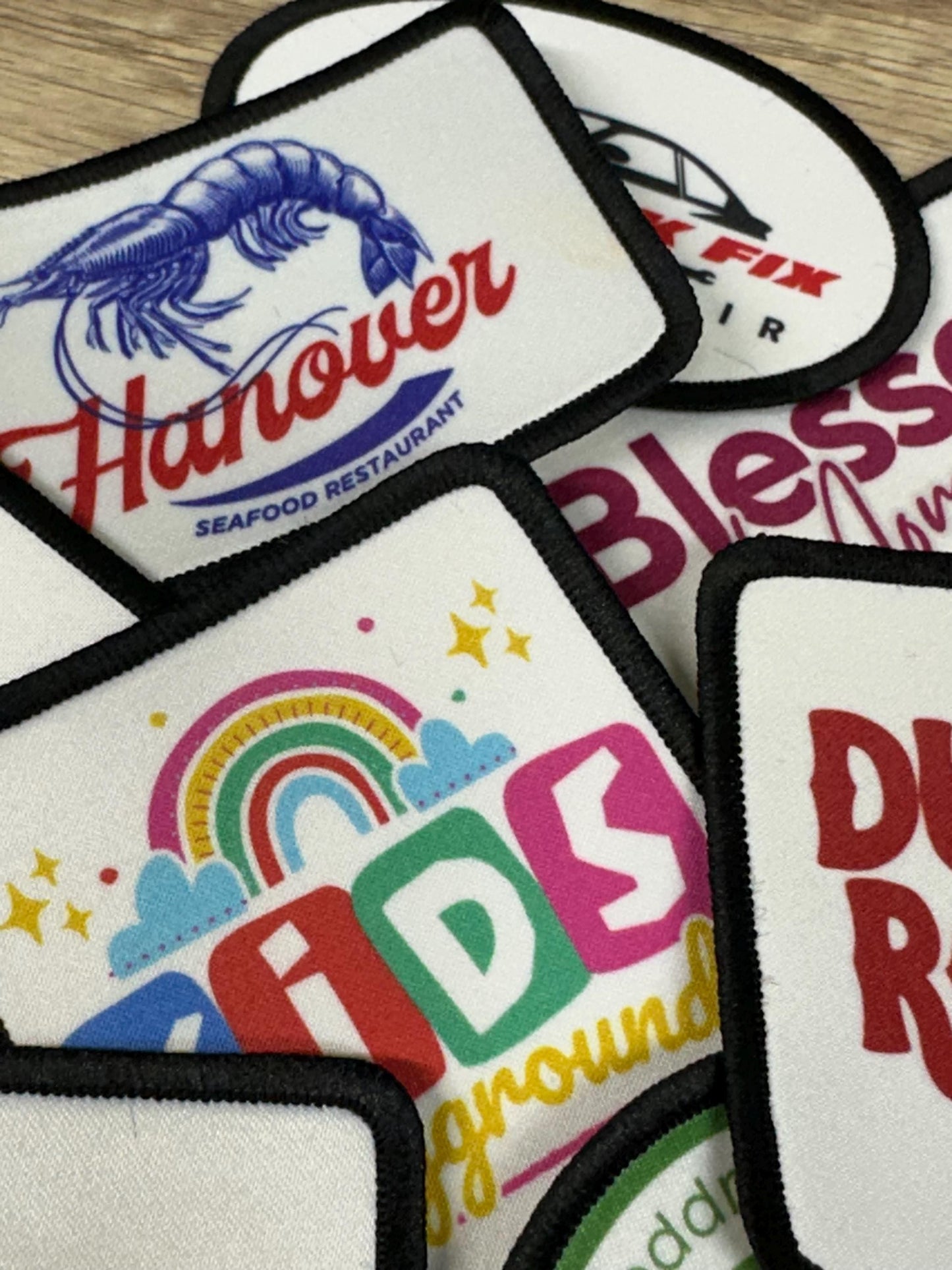 a variety of colorful patches or logos, including a large shrimp design, a rainbow, and other abstract patterns.