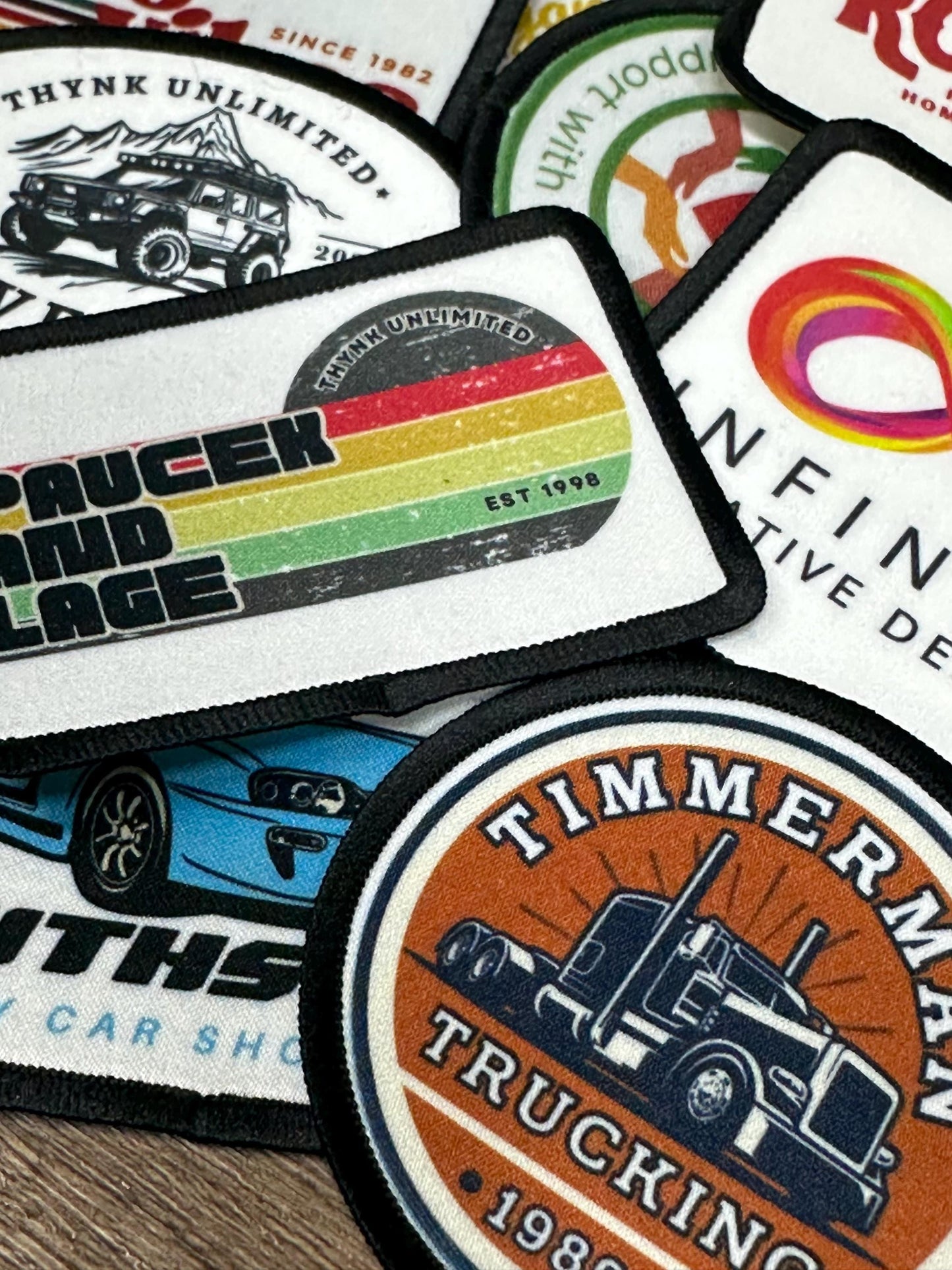 a collection of various logos and patches, including one that features a truck and another that has a colorful design.